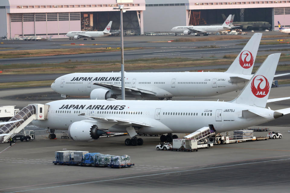 Japan Airline's planes sit on the tarmac at Haneda Airport in Tokyo, Monday, Nov. 29, 2021. Japan’s NHK national television said the country’s transport ministry on Wednesday, Dec. 1, requested international airlines to stop taking new reservations for all flights arriving in Japan until the end of December.(AP Photo/Koji Sasahara)