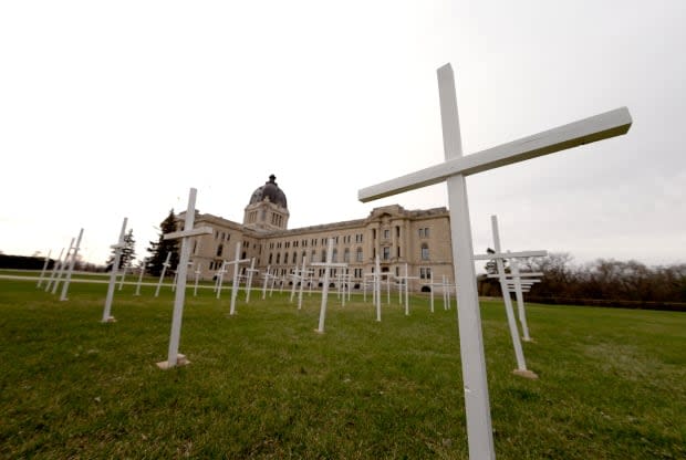 Crosses were planted in front of the Saskatchewan legislature building on Saturday morning.  (Bryan Eneas/CBC - image credit)