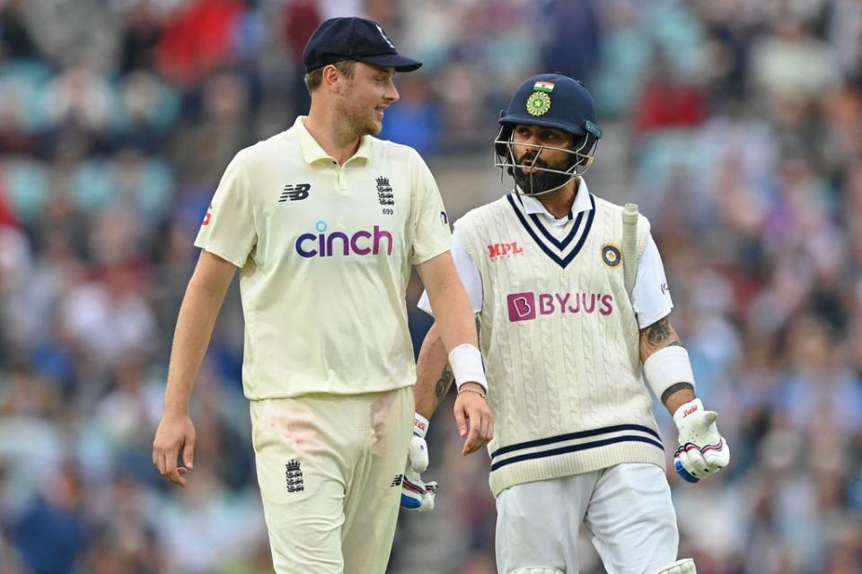 Ollie Robinson chats with Virat Kohli as players leave the field (AFP)