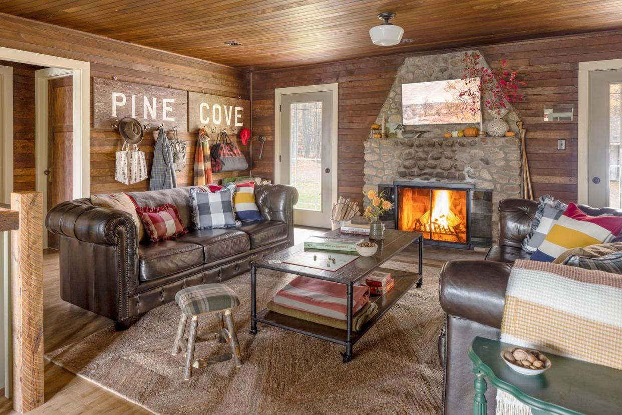 the marsh family cabin in wisconsin with a roaring fire and a leather sofa
