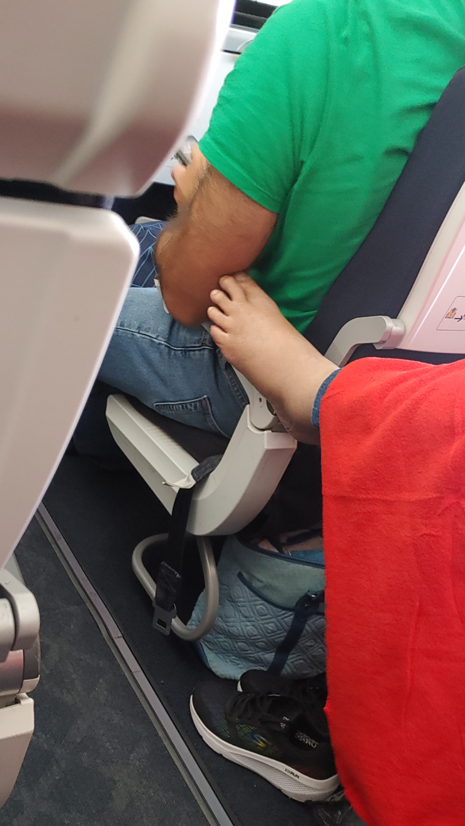 Someone's foot touching a man's arm