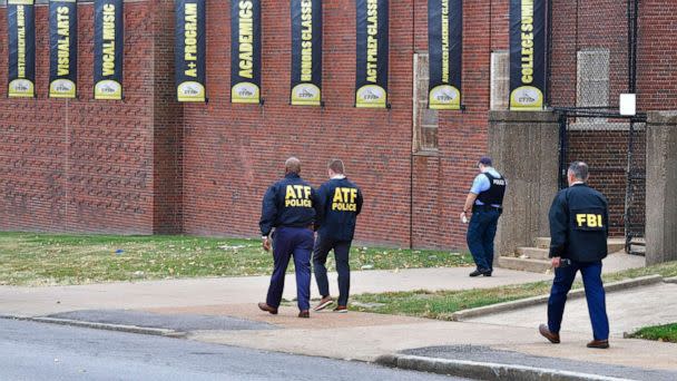 PHOTO: Alcohol, Tobacco, & Firearms agents alongside a FBI agent and a St. Louis metropolitan police officer, walk outside the north side of the Central Visual and Performing Arts High School after a shooting, Oct. 24, 2022, in St. Louis. (Tim Vizer/AFP via Getty Images)