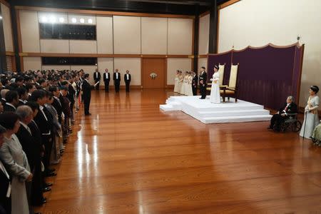 Japan's Emperor Naruhito, flanked by Empress Masako, attends a ceremony called Sokui-go-Choken-no-gi, his first audience after the accession to the throne , at the Imperial Palace in Tokyo, May 1, 2019. Japan Pool/Pool via REUTERS