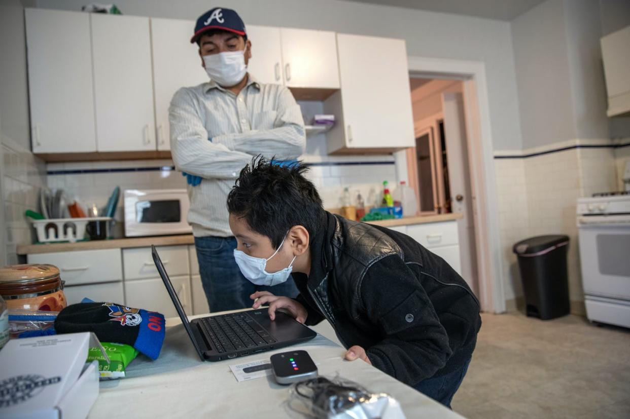 <span class="caption">A Guatemalan immigrant tries to log on to his Chromebook while remote learning in Stamford, Connecticut.</span> <span class="attribution"><a class="link " href="https://www.gettyimages.com/detail/news-photo/recovering-from-covid-19-guatemalan-immigrant-junior-tries-news-photo/1221625097?adppopup=true" rel="nofollow noopener" target="_blank" data-ylk="slk:John Moore/Getty Images;elm:context_link;itc:0;sec:content-canvas">John Moore/Getty Images</a></span>