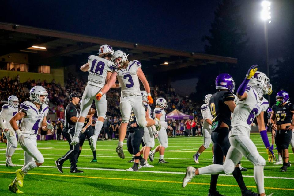 Sumner’s Kaden Malesis (18) celebrates with Austin Cook after Malesis caught a touchdown pass from quarterback Kaden Bodine during the second quarter of a 4A SPSL game against Puyallup on Friday, Sept. 23, 2022, at Sparks Stadium in Puyallup, Wash.