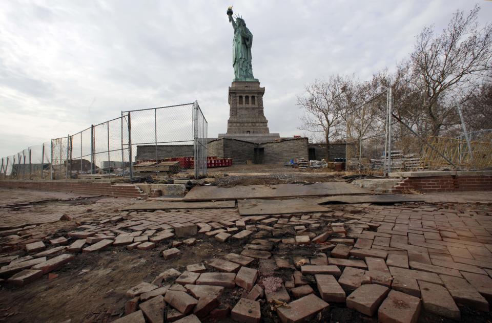 FILE - In a Nov. 30, 2012 file photo, parts of the brick walkway of Liberty Island that were damaged in Superstorm Sandy are shown during a tour of New York’s Liberty Island. After hundreds of National Park Service workers from as far away as California and Alaska spent weeks cleaning and making repairs, the island will reopen to the public on Independence Day, July 4, 2013. (AP Photo/Richard Drew, File)