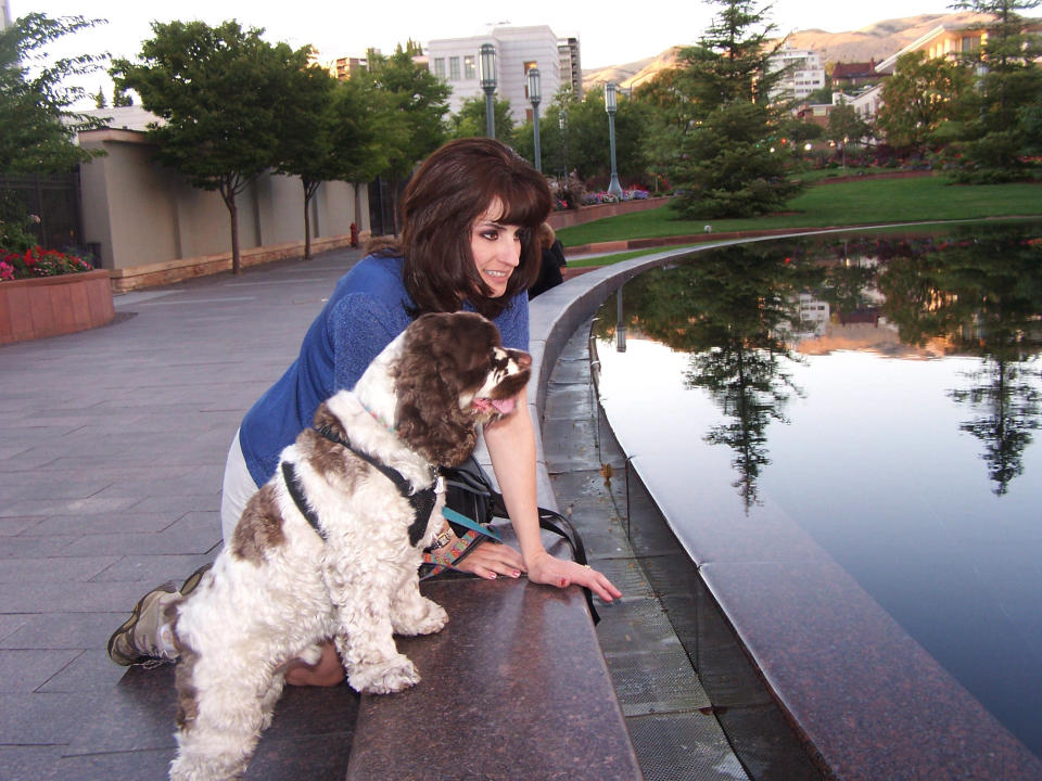 This undated photo shows Carol Bryant of Forty Fort, Pa., and her cocker spaniel, Dexter, at Salt Lake City Temple during the BlogPaws conference in Salt Lake City, Utah. Dexter travels the country with Bryant, a blogger who spends her time meeting other pet owners. Dexter often breaks the ice because he knows no strangers and even has his own business cards. (AP Photo/Carol Bryant, Darlene Bryant)