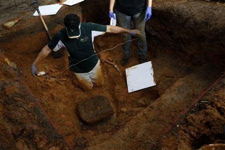 University of South Florida associate professor Christian Wells uses string in an attempt to cut loose a block of dirt and clay containing skull fragments in a grave at the now closed Arthur G. Dozier School for Boys in Marianna, Florida, September 2, 2013. REUTERS/Edmund D. Fountain/Pool