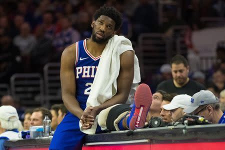 Apr 15, 2019; Philadelphia, PA, USA; Philadelphia 76ers center Joel Embiid (21) rest on the scorers table during the second quarter in game two of the first round of the 2019 NBA Playoffs against the Brooklyn Nets at Wells Fargo Center. Mandatory Credit: Bill Streicher-USA TODAY Sports