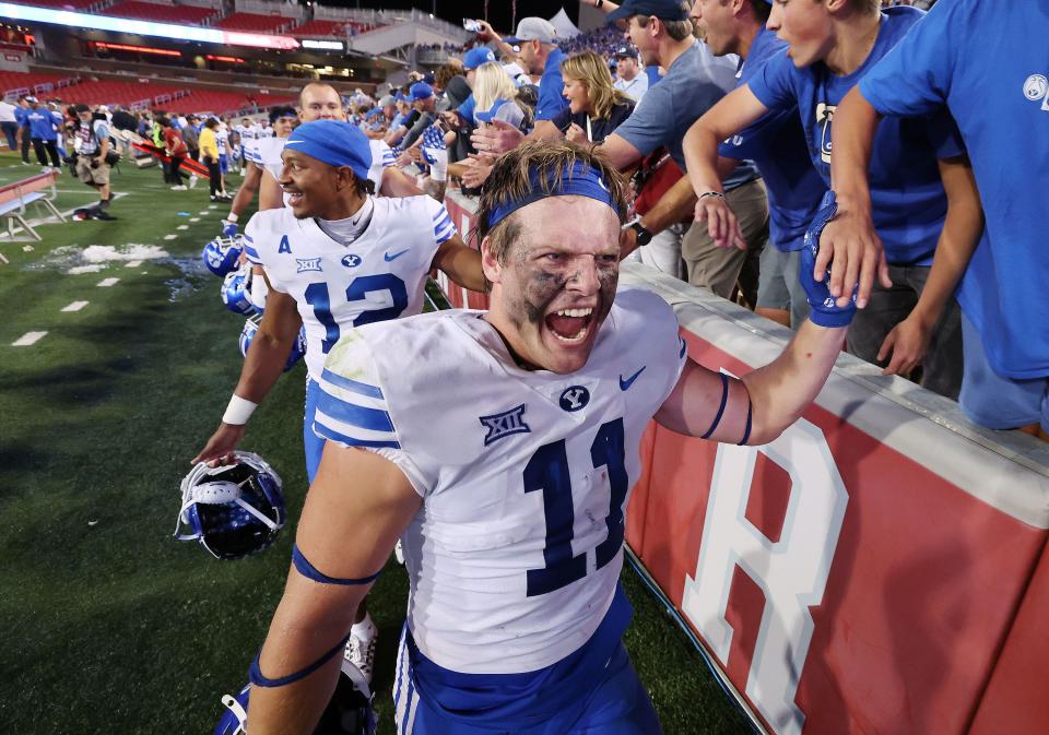 BYU Cougars linebacker Harrison Taggart (11) celebrates the win over the Arkansas Razorbacks with BYU fames at Razorback Stadium in Fayetteville on Saturday, Sept. 16, 2023. BYU won 38-31. | Jeffrey D. Allred, Deseret News