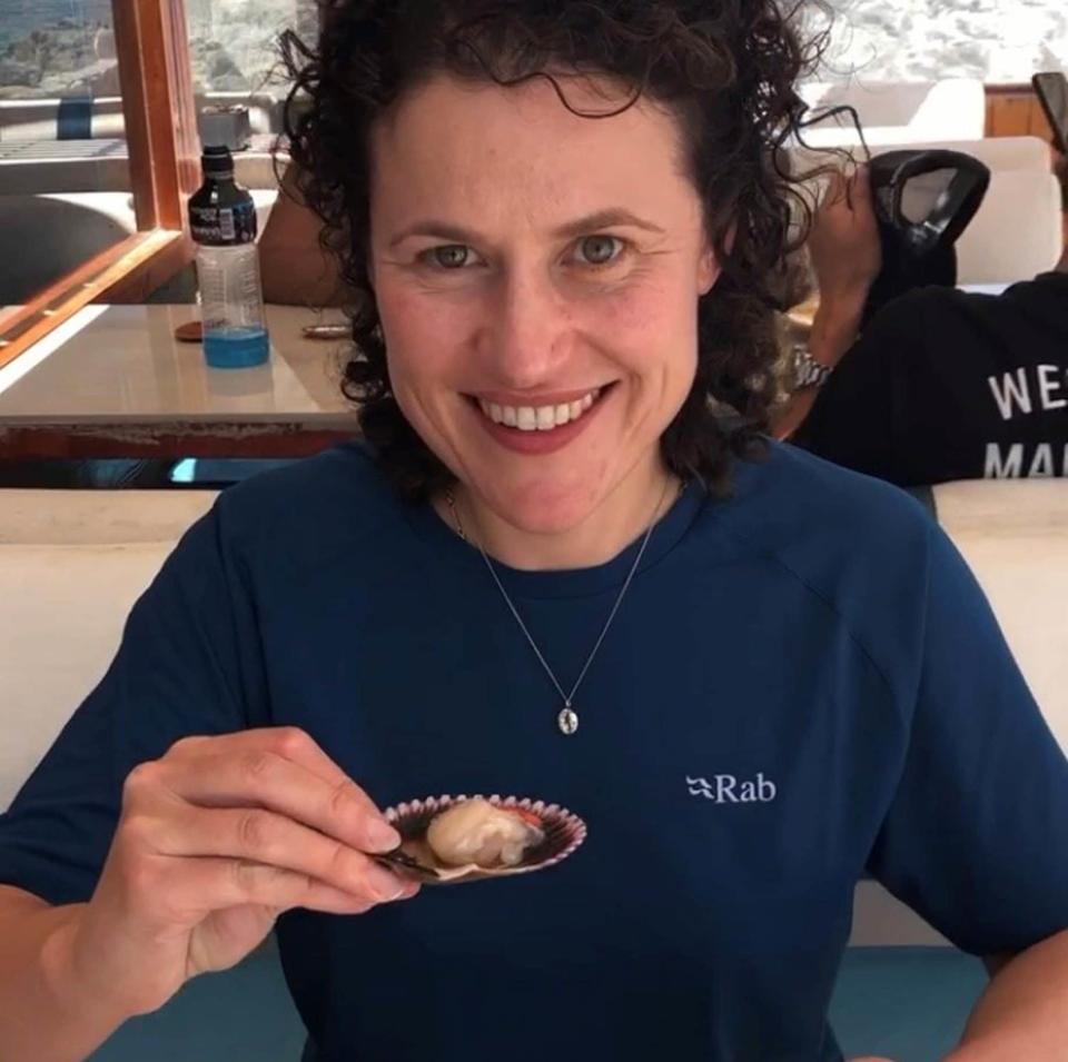 Sarah eating a raw scallop in Bahia Inglesa - Sarah Marshall