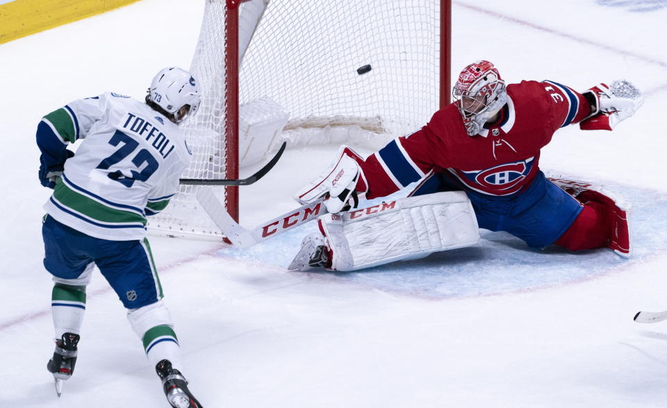 Vancouver Canucks' Tyler Toffoli scores past Montreal Canadiens goaltender Carey Price during overtime in an NHL hockey game Tuesday, Feb. 25, 2020, in Montreal. (Paul Chiasson/The Canadian Press via AP)