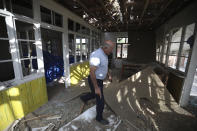 A man walks inside his destroyed house in a residential area after shelling by Armenian forces in Tartar, the capital of the Tartar region of Azerbaijan, Monday, Oct. 26, 2020. Armenia and Azerbaijan are accusing each other of violating the new U.S.-brokered cease-fire aimed to halt the fighting over the separatist region of Nagorno-Karabakh. (AP Photo/Aziz Karimov)