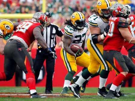 Dec 21, 2014; Tampa, FL, USA; Green Bay Packers running back Eddie Lacy (27) runs with the ball during the second half against the Tampa Bay Buccaneers at Raymond James Stadium. Green Bay Packers defeated the Tampa Bay Buccaneers 20-3. Mandatory Credit: Kim Klement-USA TODAY Sports