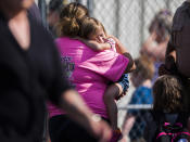 <p>A child holds onto a caretaker after being picked up by her at Oakdale Baptist Church, following a shooting at Townville Elementary in Townville Wednesday, Sept. 28, 2016. (Katie McLean/The Independent-Mail via AP) </p>