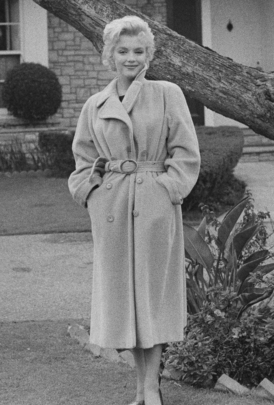 Marilyn Monroe (1926 - 1962) poses outside her home during a photo call, California, USA, 1956