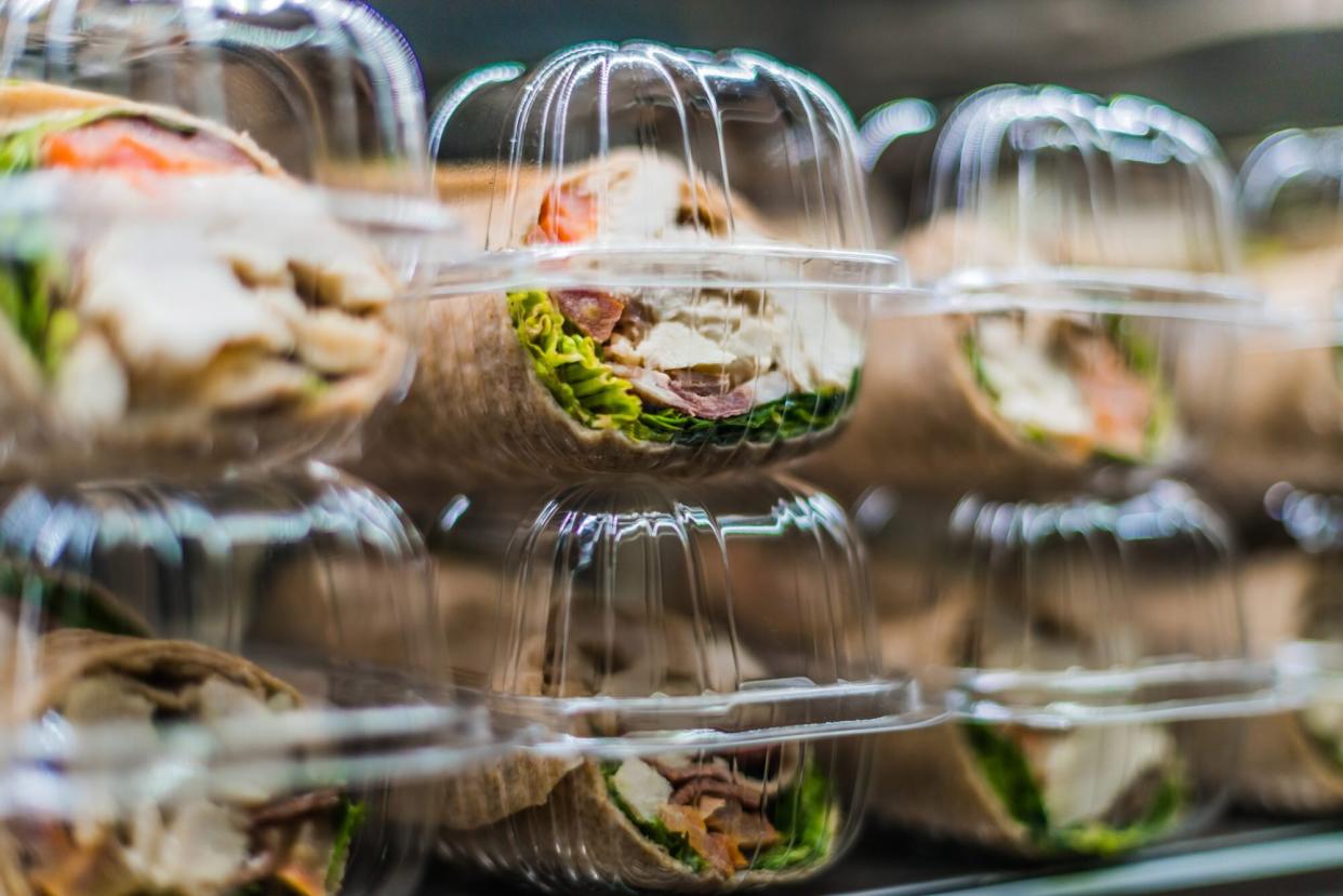 Pre-packaged sandwiches displayed in a commercial refrigerator