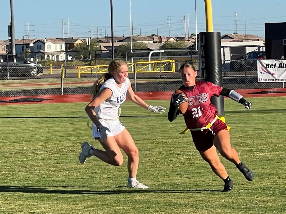 Desert Ridge's Kaitlyn Medina (right) tries to avoid Sandra Day O'Connor's Bella Wolf during their flag football game on Sept. 19, 2023.