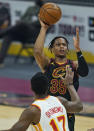 Cleveland Cavaliers' Isaac Okoro (35) shoots over Atlanta Hawks' Onyeka Okongwu (17) in the first half of an NBA basketball game, Tuesday, Feb. 23, 2021, in Cleveland. (AP Photo/Tony Dejak)