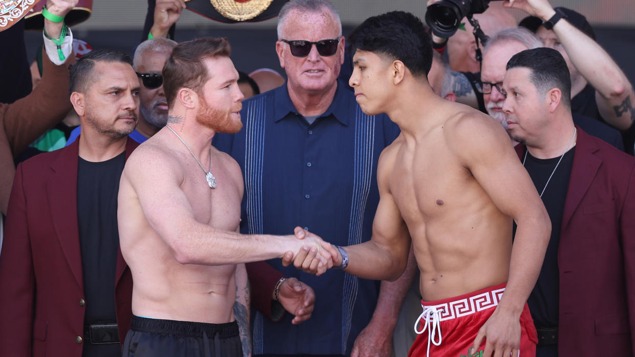  Canelo (L) and Munguia (R) shake hands at the weigh-in. 