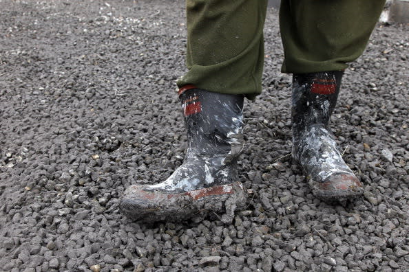 Karen Martin shows off the ash stuch to her gumboots after Mt Tongariro erupted for the first time in over 100 years on August 7, 2012 in Tongariro National Park, New Zealand. Mt Tongariro erupted intermittently from 1855 to 1897. Although not an immediate threat to the community, the latest eruption may be the beginning of weeks, months or even years of volcanic activity. (Photo by Hagen Hopkins/Getty Images)