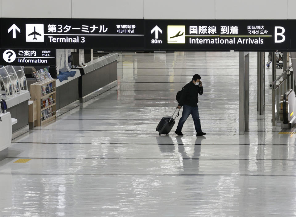 An international arrivals lobby is deserted at Narita International Airport in Narita, east of Tokyo, Japan, Monday, Nov. 29, 2021. Japan’s NHK national television said the country’s transport ministry on Wednesday, Dec. 1, requested international airlines to stop taking new reservations for all flights arriving in Japan until the end of December. (Miyuki Saito/Kyodo News via AP)