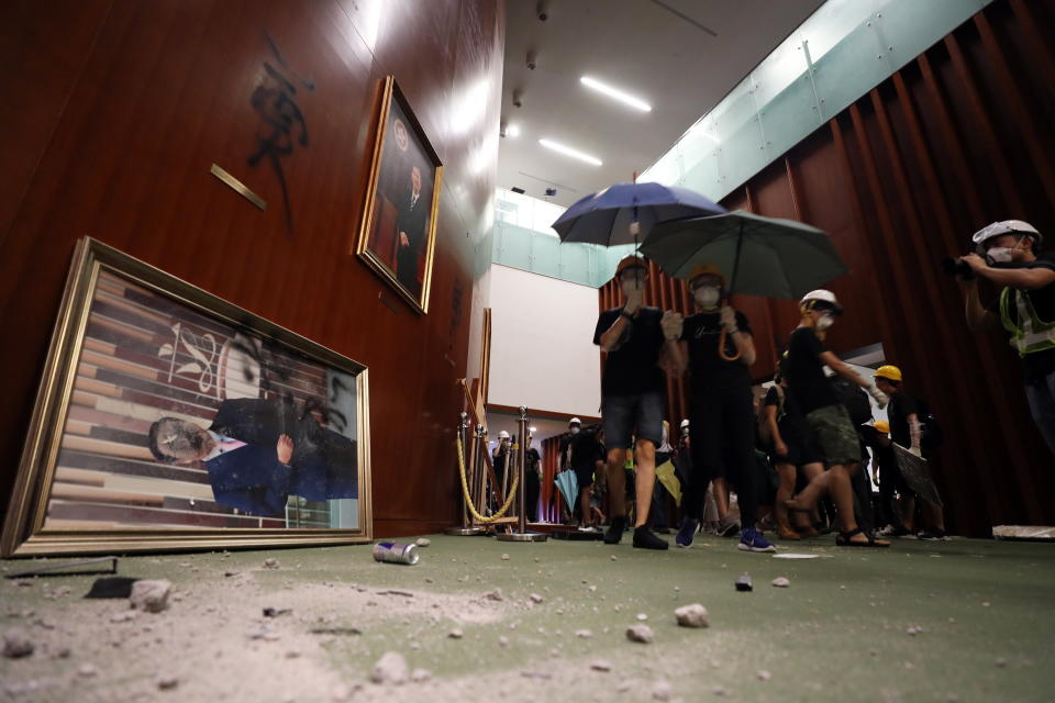 Protesters wonder through the halls of the Legislative Council building, trashing the place. Source: AAP/RITCHIE B. TONGO