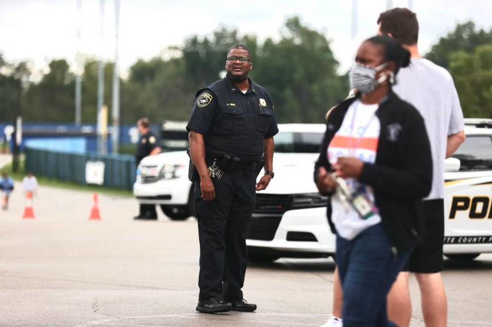 Parents and guardians gather outside Henry Clay High School in Lexington, Ky., after a bomb threat was reported at the school.