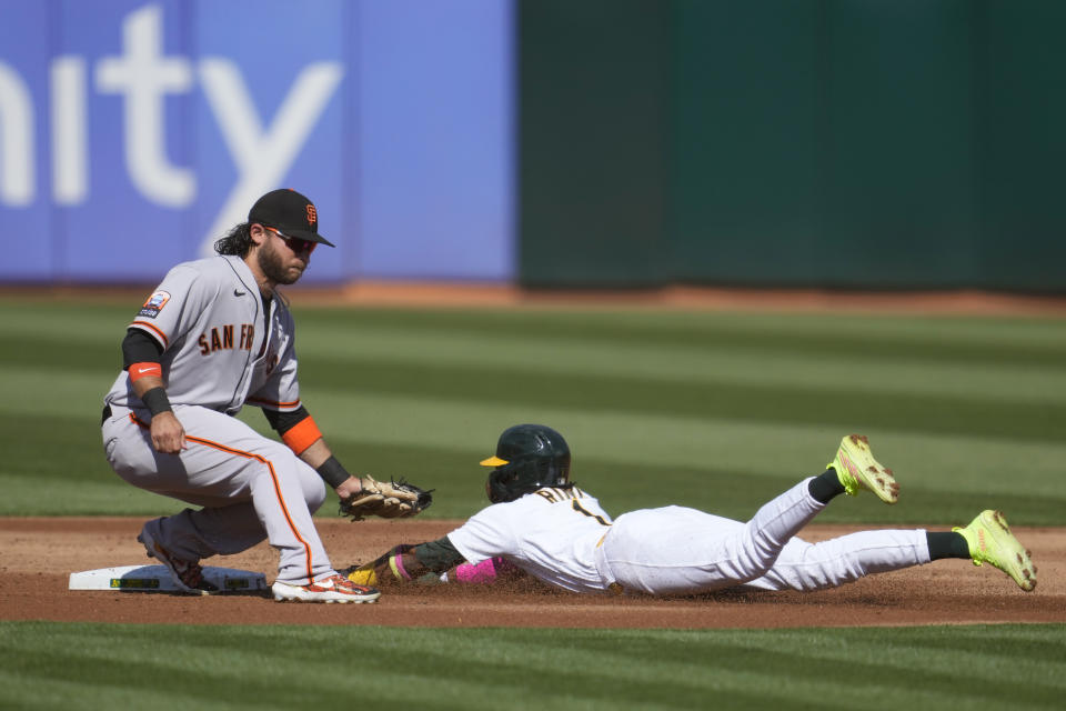 Oakland Athletics' Esteury Ruiz, right, steals second base next to San Francisco Giants shortstop Brandon Crawford during the first inning of a baseball game in Oakland, Calif., Saturday, Aug. 5, 2023. (AP Photo/Jeff Chiu)