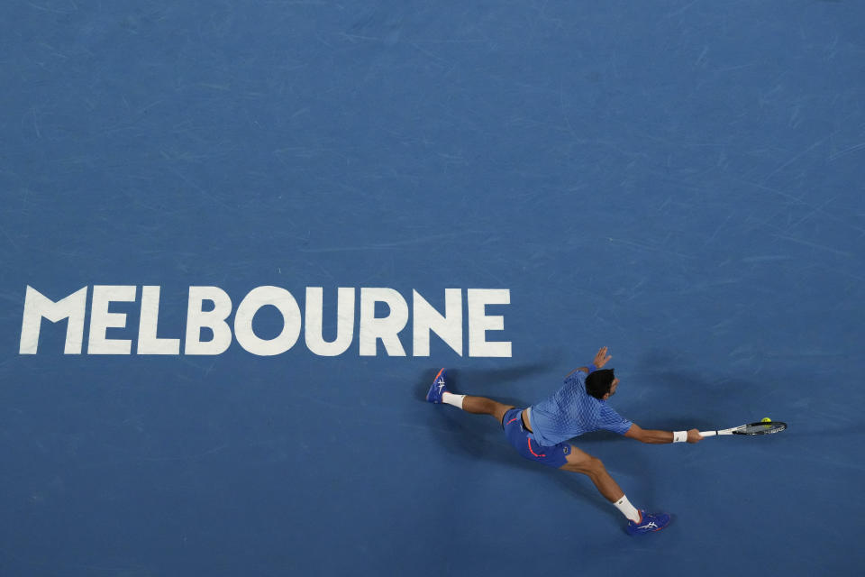 Novak Djokovic of Serbia plays a forehand return to Stefanos Tsitsipas of Greece during the men's singles final at the Australian Open tennis championships in Melbourne, Australia, Sunday, Jan. 29, 2023. (AP Photo/Ng Han Guan)