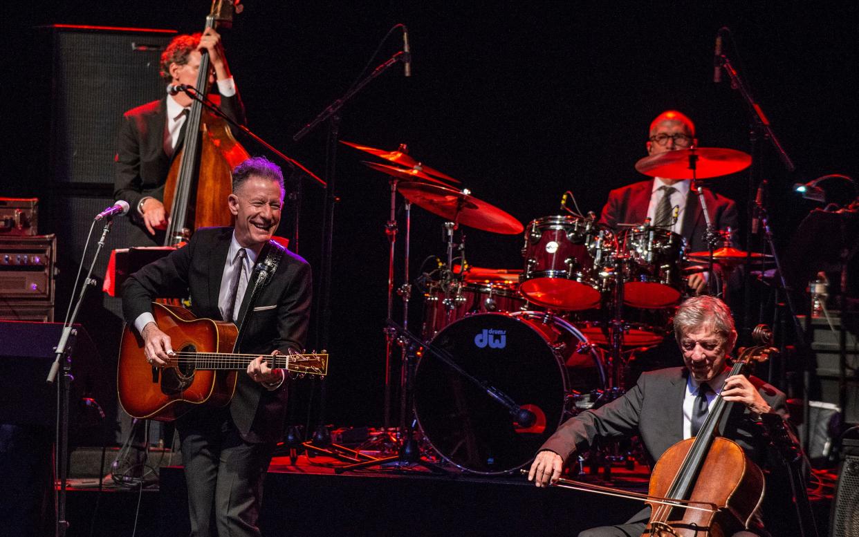 Lyle Lovett and His Large Band are set to perform July 24 at Newport Music Hall. Lovett, left with guitar, is a four-time Grammy winner.