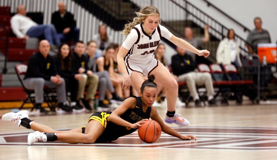 Tri-Valley's Lexi Howe, bottom, and John Glenn's Kylah Morgan chase after a loose ball on Jan. 11 in New Concord.