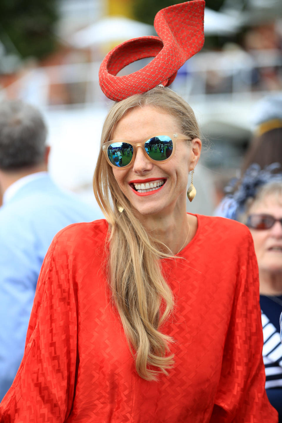 This racegoer teamed on point mirrored sunnies with an eye-catching tangerine ensemble, complete with a structured hat. 