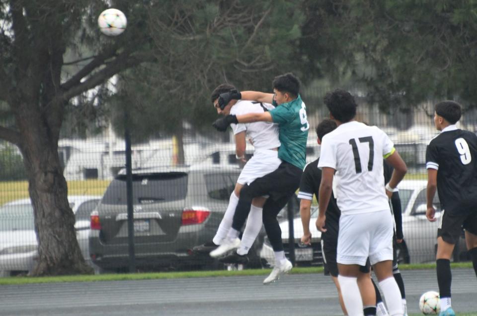 Pacifica goalie Ruben Lopez goes after the ball while being challenged by Oxnard's Pabel Ayala during the Tritons' 4-0 win in a Channel League match on Saturday, Jan. 20, 2024.
