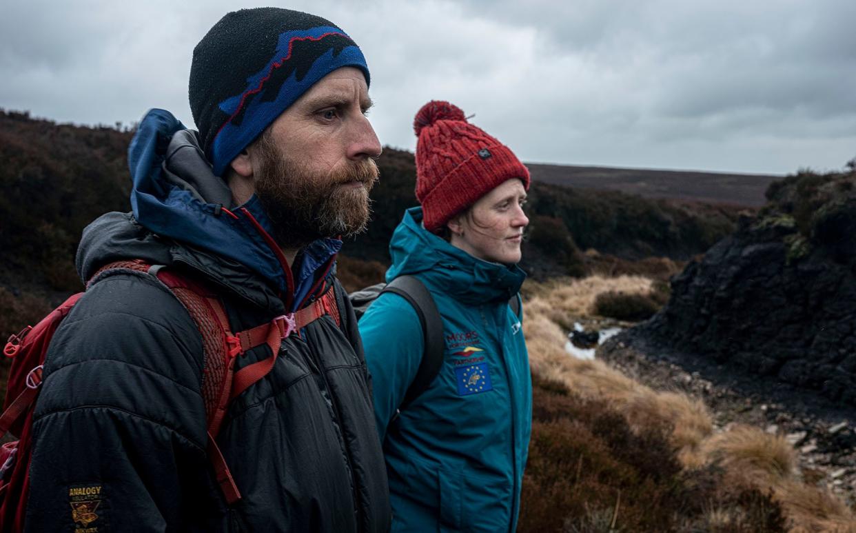 Alice Pearson and Tom Spencer of The Moors For The Future Partnership survey exposed peat - Alixandra Fazzina