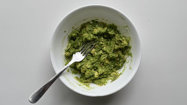 guacamole in bowl with fork