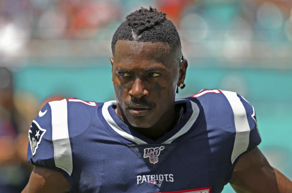 In this Sunday, Sept. 15, 2019, photo, New England Patriots wide receiver Antonio Brown waits for the team's NFL football game against the Miami Dolphins to begin in Miami Gardens, Fla. \Brown was released by the Patriots on Friday, Sept. 20, after a second woman accused him of sexual misconduct. (David Santiago/Miami Herald via AP)