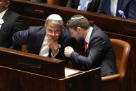 Israeli right wing Knesset member Itamar Ben Gvir, left, and Bezalel Smotrich, right, talk with each other during the swearing-in ceremony for Israeli lawmakers at the Knesset, Israel's parliament, in Jerusalem, Tuesday, Nov. 15, 2022. Israeli lawmakers were sworn in at the Knesset, on Tuesday, following national elections earlier this month. (Abir Sultan/Pool Photo via AP)