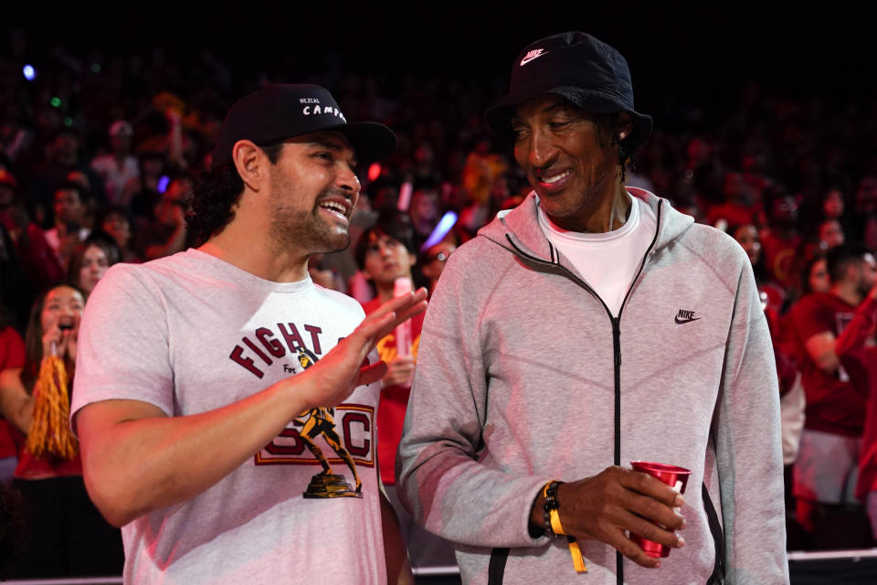 Former Southern California and NFL quarterback Mark Sanchez, left, speaks with former NBA player Scottie Pippen during the first half of an NCAA college basketball game between Southern California and UCLA, Saturday, Jan. 27, 2024, in Los Angeles. (AP Photo/Ryan Sun)