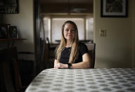 Rebecca Leavitt poses for a portrait at her home Monday, April 8, 2024, in Las Vegas. Leavitt was part of a Nevada wildfire crew sent to mop up a wildfire hotspot. A class-action lawsuit resulted in a $340,000 settlement and better training and equipment going forward. Rebecca Leavitt said when she and her all-woman team arrived at the site with only classroom training, they did a "hot foot dance" on smoldering embers as their boss yelled "Get back in there!" One crew member's burned-up boots were duct-taped back together, while others cried out in pain as their socks melted to their feet during a nine-hour shift that paid about $1 an hour. (AP Photo/John Locher)