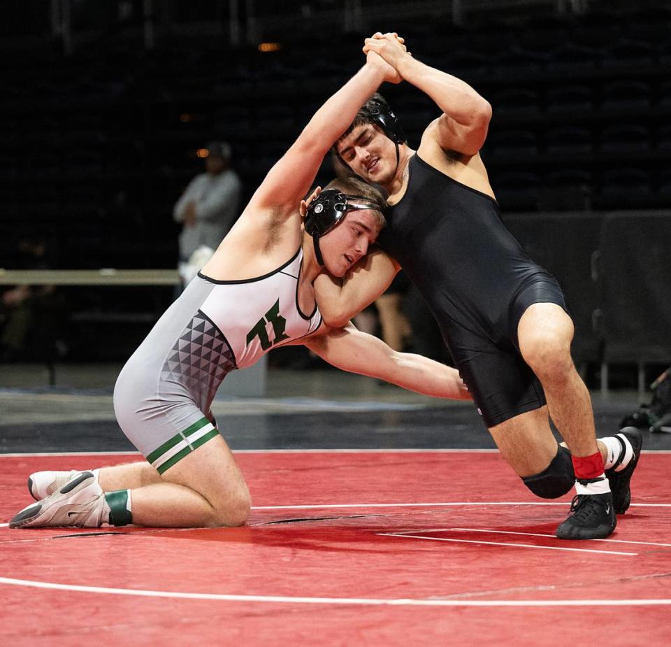 Arjun Nagra of Vacaville, right, and Pitman’s Brodie Johnson battle in the 165-pound title match during the Sac-Joaquin Section Masters Wrestling Championships at Stockton Arena in Stockton, Calif., Saturday, Feb. 17, 2024. Nagra claimed the title 4-3.