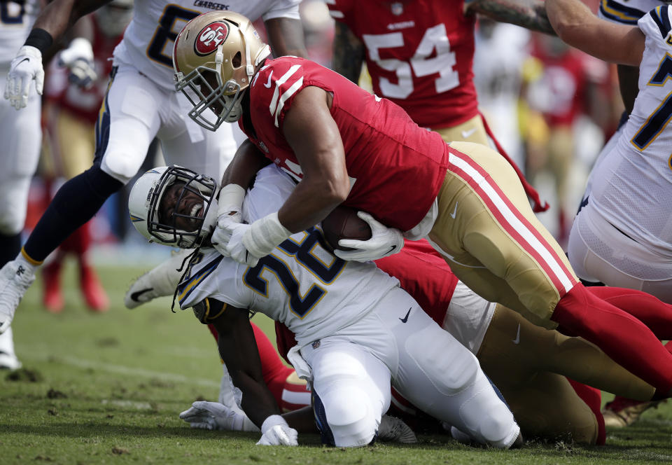 San Francisco 49ers defensive end Arik Armstead, right, stops Los Angeles Chargers running back Melvin Gordon during the first half of an NFL football game, Sunday, Sept. 30, 2018, in Carson, Calif. (AP Photo/Jae Hong)