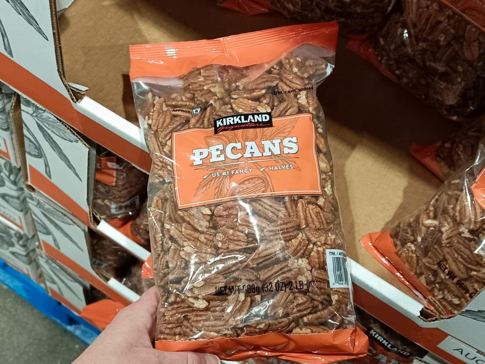 The writer holds pack of Kirkland Signature pecans