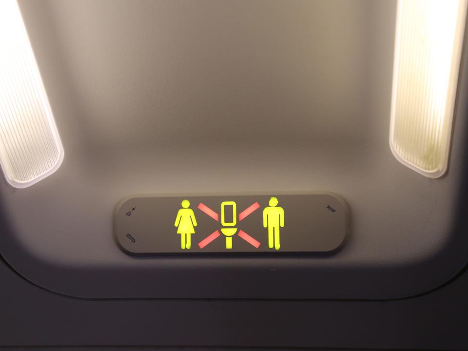 occupied lavatory lit up on an airplane