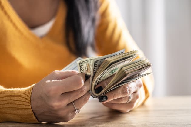 A woman counts many American bills - Close up.