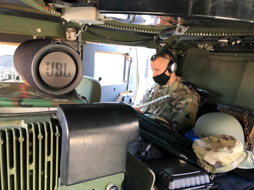 Sergeant Kohut packed his flute and taught his virtual band class like he always would – except he was sitting in a military vehicle, parked outside of the U.S. Capitol.  / Credit: Jacob Kohut