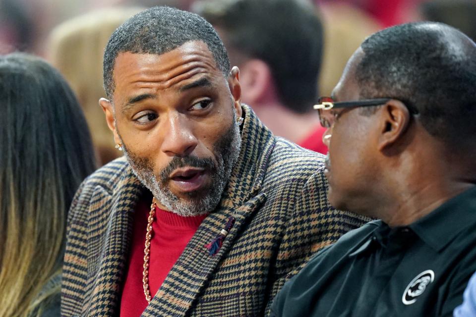 Former Cincinnati Bearcats player Kenyon Martin sits courtside in the first half of the 90th Crosstown Shootout college basketball game between the Xavier Musketeers and the Cincinnati Bearcats, Saturday, Dec. 10, 2022, at Fifth Third Arena in Cincinnati. 