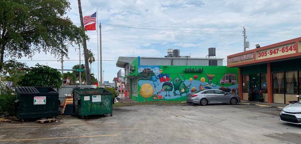 Le Genie Restaurant on the right, dumpsters on the left, open and closer to the front entrance than is healthy.