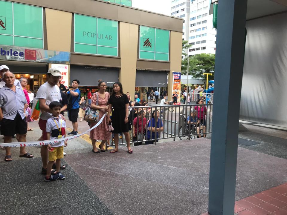 Bystanders outside Jubilee Square after a fire broke out at Block 720 Ang Mo Kio Ave 6. PHOTO: Bryan Huang/Yahoo News Singapore 