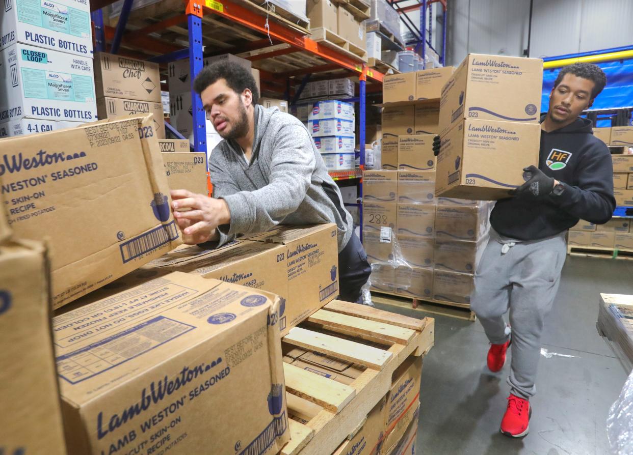 Hillcrest Food Service workers Desean Beckman, left, and Alex Sailes load up Lamb Weston fries at the warehouse on Friday, Jan. 26, 2024, in Cleveland, Ohio.. [Phil Masturzo/ Beacon Journal]